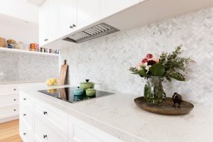 A kitchen staged with flowers and cookware